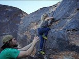 Four-year-old Hadlie Brechler shows off her rock climbing skills