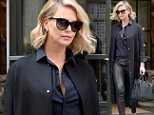 Charlize Theron shows off her legs in leather leggings