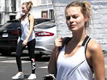 Makeup free Margot Robbie flaunts fit figure in activewear