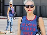 Gwen Stefani shows a bit of bra beneath upbeat tank top