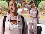 Christina Milian flashes abs as she jets to Sydney