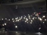 Audience lights stage with cell phones during school play