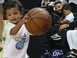 DJ Khaled's sweet son Asahd, 18 months, tries his hand at basketball as he watches Miami Heat game