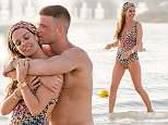 Danielle Lloyd sizzles in a crochet bikini as she packs on the PDA with fiance Michael in Dubai
