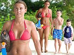 Coleen Rooney displays her slender post-baby physique in a coral bikini during Barbados getaway