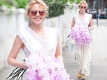 Kylie Minogue, 50,holds bouquet of flowers in London after smitten sightings with beau Paul Solomons