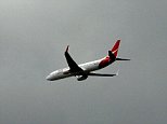 Qantas flight is forced to turn around and head back to Sydney after being struck by lightning