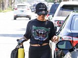 Vanessa Hudgens flashes belly button ring as she leaves gym  in Harley Davidson top and leggings